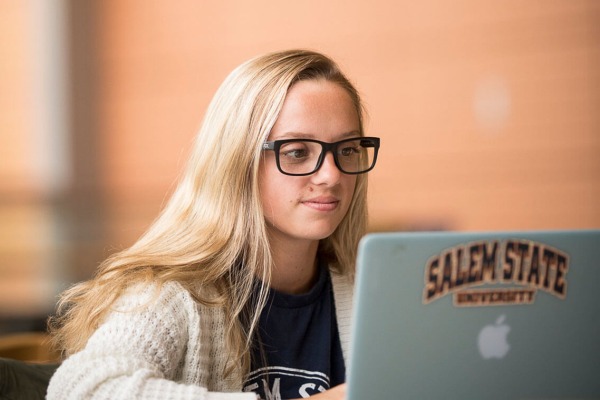 Female student on laptop in library