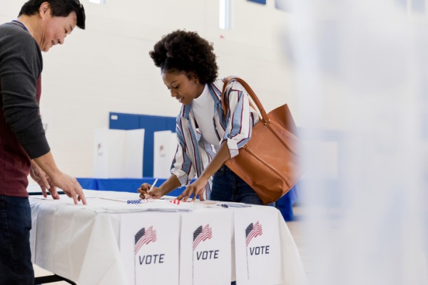 A student votes at her local polling location