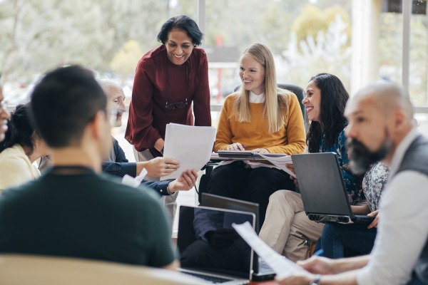 A group of teachers gathered in a circle talking