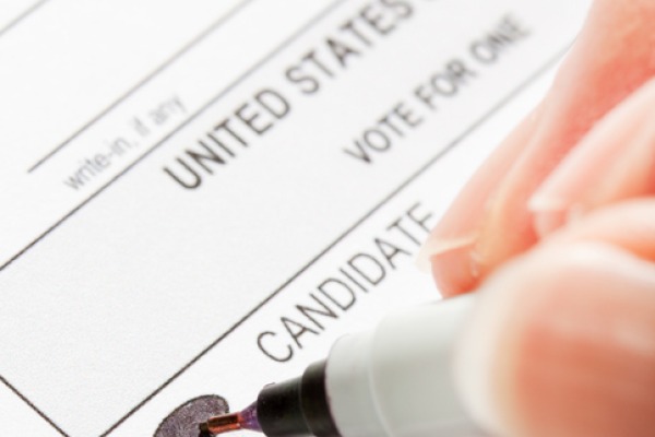 a close up of a ballot with a marker filling in a choice