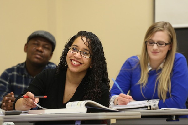 Students taking notes in a classroom