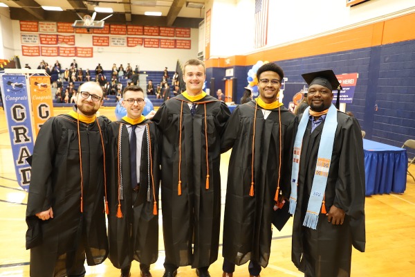 A group of graduate school students at commencement