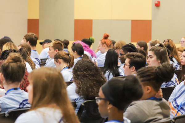 a group of students sit at an event