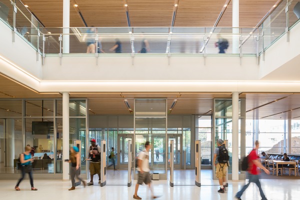 Students walking through the library lobby