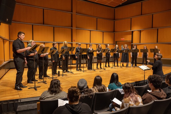 The Salem State chorus on stage in the recital hall