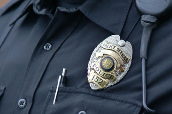 A police officer's badge displayed on his chest.
