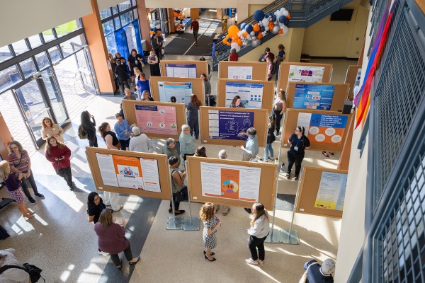 A photo of the Classroom Building atrium with research posters set up, students and faculty on Research Day