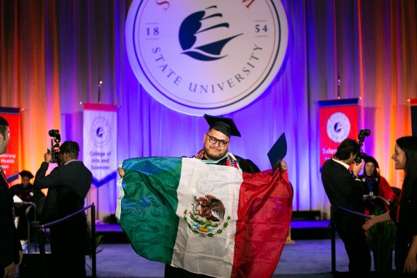 Student with Mexican flag at commencement