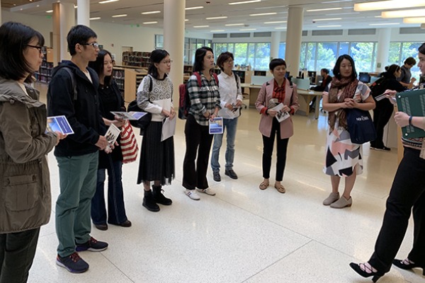 A group of visiting scholars in the Berry Library atrium