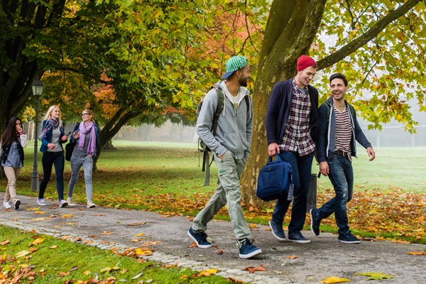 Students outside walking in small groups