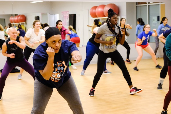 A group of students in a boxing class in the fitness studio