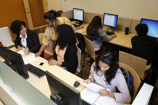 students working at computers with instructor assistance
