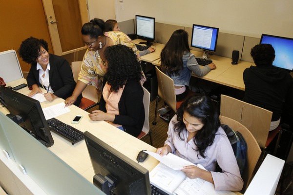 students working at computers with instructor assistance