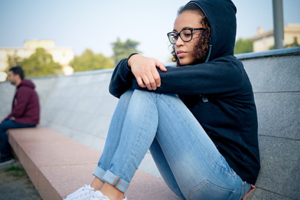 Sad young afro-american girl alone in the city street