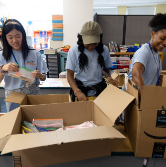 Salem State University volunteers pack bags of school supplies at Sarah Parker Remond School in Salem as part of First Year Day of Service