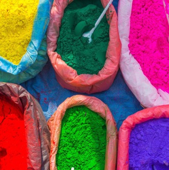 Image of 4 bags of vivid-colored paint powder.