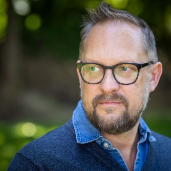 Peter Swanson with glasses and a blue shirt
