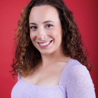 Woman in purple top in front of red background