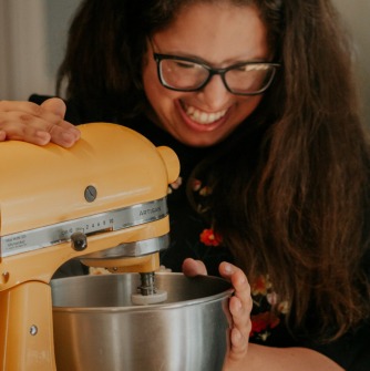Dayna Altman smiling looking into her mixing bowl.