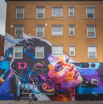 A mural of a lovely Latinx woman, looking up.
