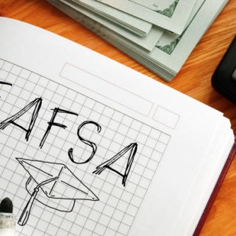 FAFSA and a graduation hat drawn on a ruled notebook