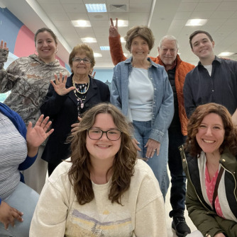A group of SSU students and older adults waving. 