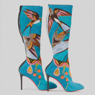 Two high-heeled, blue boots with beading that depicts birds in flight.