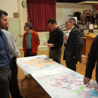 GIS graduate students and professor Luna discuss maps with Amesbury residents