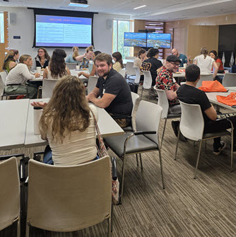 Graduate students talking and engaging at Fall 2025 Graduate Student Orientation