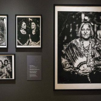 A photo of black and white framed photographs of indigenous people that are featured at the Peabody Essex Museum.