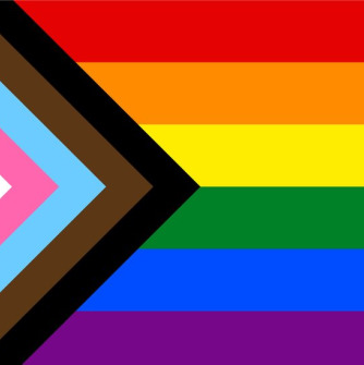 An image of the Progress Pride Flag, which includes colored rainbow stripes to represent LGBTQIA+ identities.