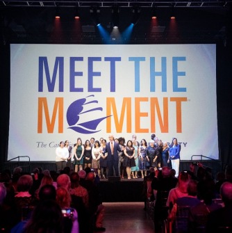 Meet the Moment® campaign kickoff with President Keenan on stage with students, community members and others