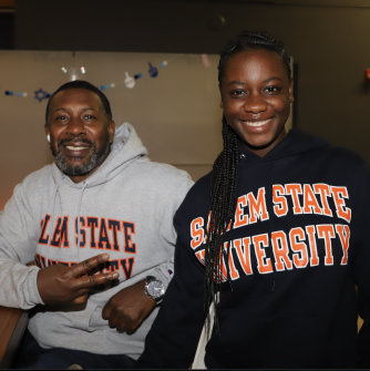Two people in Salem State Hoodies Smiling