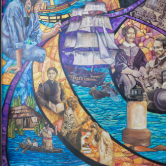 In “Chronicles of Salem Change Makers,” a sweeping wave carries you through Salem’s full story, from the people of Naumkeag who first fished these shores, through the abolitionists, immigrants, and changemakers who built this city, to the students living that history today. Painted in the vibrant language of stained glass, every face in this mural belongs to this community. It doesn’t conclude the story. It opens it.