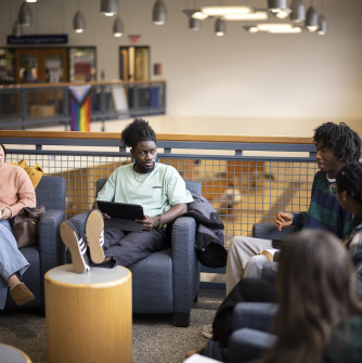 Three students study in common area. 