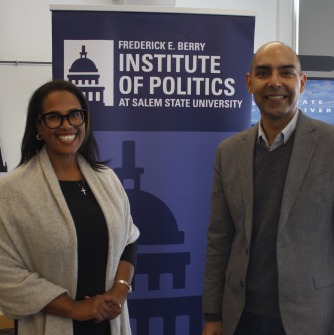 Tanisha Sullivan and Jon Santiago stand together in front of a Berry Institute of Politics banner