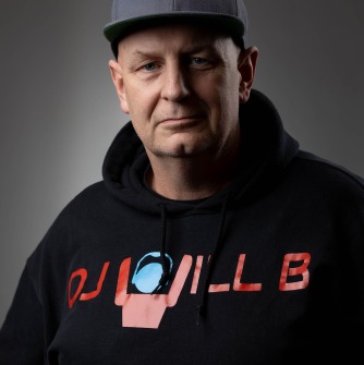 DJ Will Barbra wearing black hat and black sweatshirt