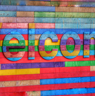 The word welcome in multicolor panels