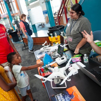 A family visits the drone demonstration with SSU Geography and Sustainability professor Marcos Luna and graduate GIS student Jeannette Miranda