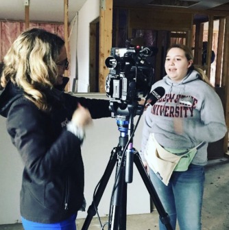 Gabriella Cullenburg talks to a television reporter during a Habitat for Humanity trip.