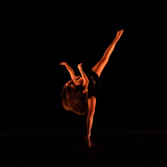 Solo dancer with leg extended perpendicular to the ground