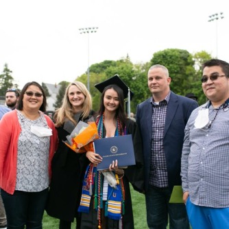 Graduate and family members pose together after ceremony