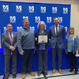 Tara in center holding award, Scott Davidson (Energy Manager at Salem State) second from left.