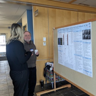 An SSU student is presenting her poster