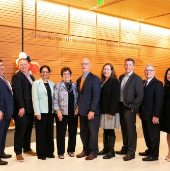 John McQuillan, Dean Atkins, Raminder Luther, Joan Feeley, John D. Keenan, Kelly Feeley, Jason Maxwell, Michael Poirier, and Cheryl Webster Crounse at the naming celebration