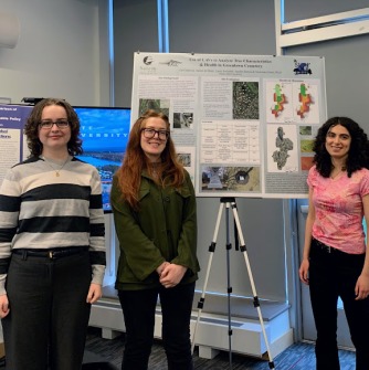 Cat CanavanDysthe, Jackie de Haan, Laura Swindell, and Jayden Barton (not pictured) stand by their first place-winning poster at the Earth Days award ceremony