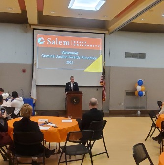 Paul Tucker speaks to a room of award-winning criminal justice students at Salem State.