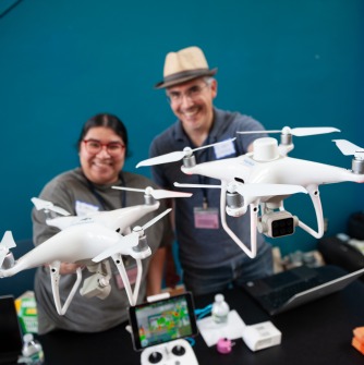 Graduate GIS student Jeannette Miranda and Geogrpahy and Sustainability Professor Marcos Luna show off drones at CT Science Center for Latino Conservation Week