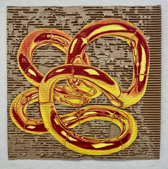 Gold sculpture on cardboard