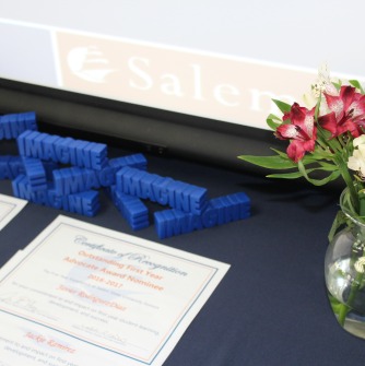 Image of certficates and flowers, with 3-D words spelling out "Imagine"